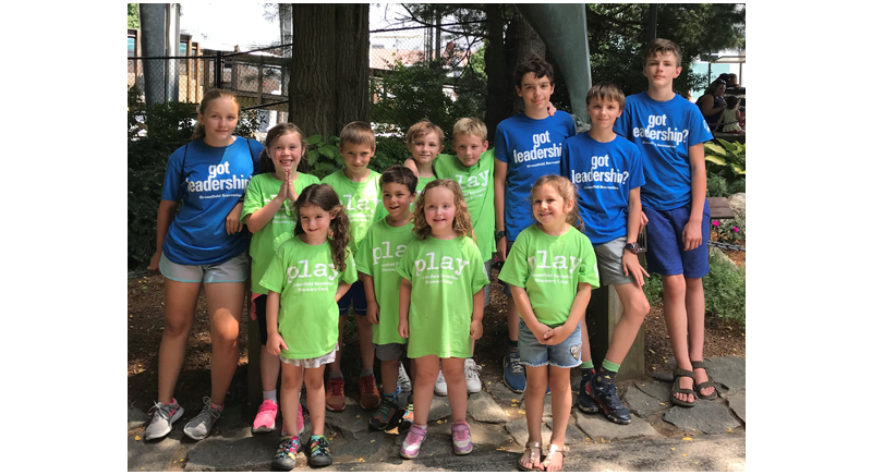 four camp counselors and eight kids on a field trip